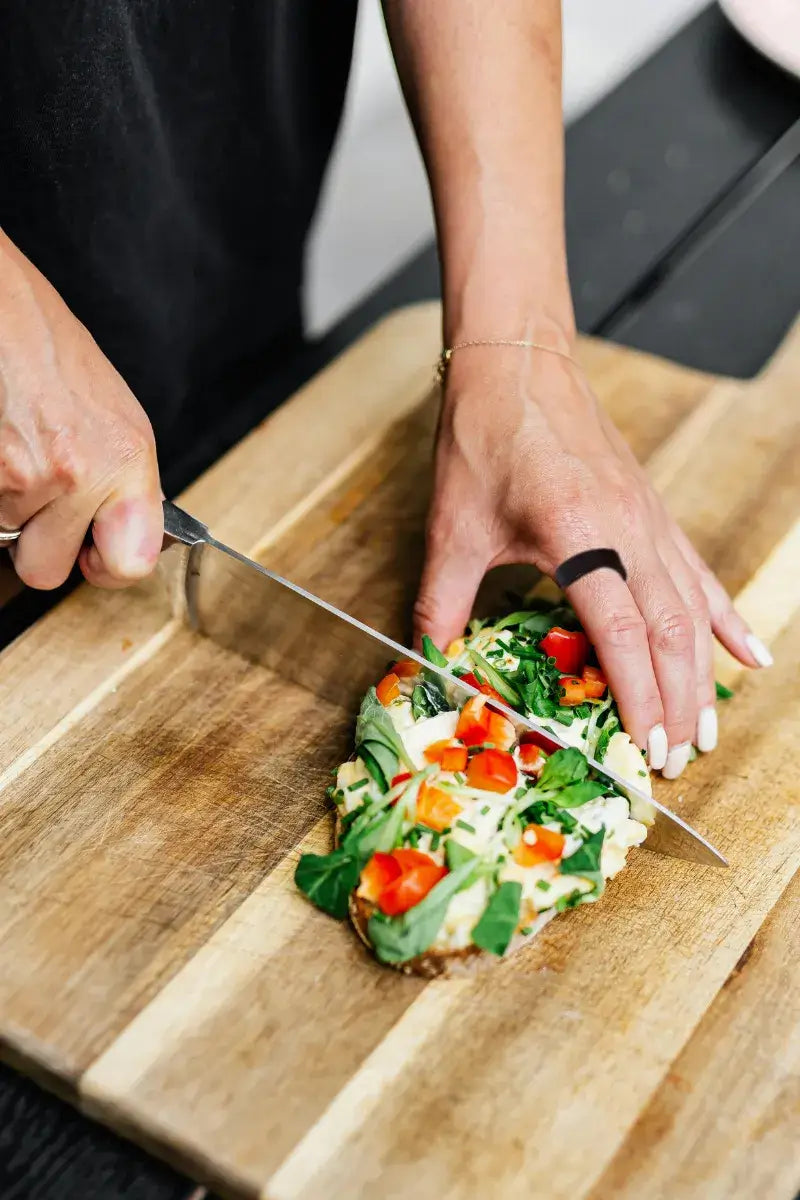 A woman whom wearing jupitercore care smart ring is preparing breakfast showing care wraps in strength