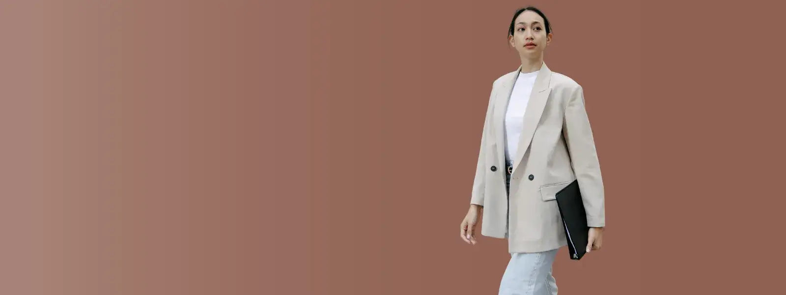 Confident businesswoman walking in a stylish blazer, promoting corporate benefits and productivity with smart rings.