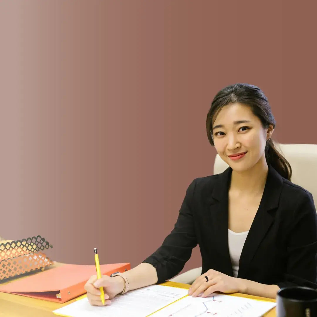 Professional woman at desk with documents, emphasizing corporate benefits and team empowerment for productivity.